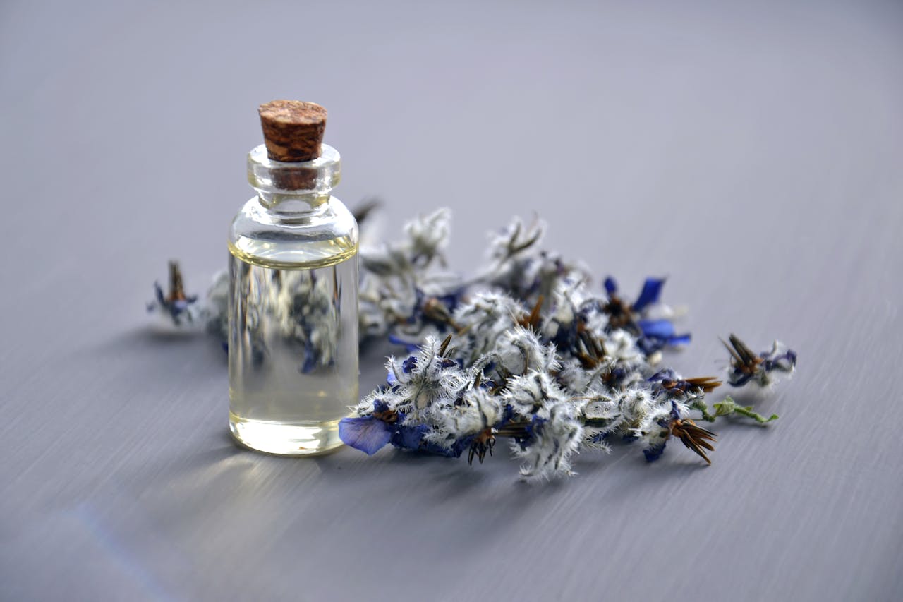 Home Close-up of a lavender oil bottle with dried flowers for aromatherapy. Perfect for wellness themes.